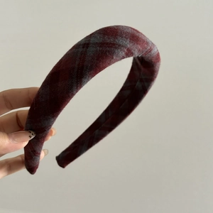 Detailed close-up of thick sponge-padded vintage plaid headband in wine red and grey wool
