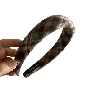 Handmade vintage plaid wool headband featuring a brown bow design on a white background