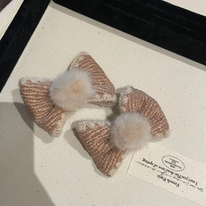 Pair of sweet beige and brown knit bow hair clips with soft plush ball center