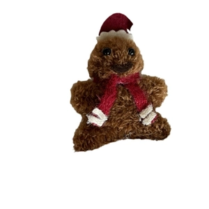 Cute gingerbread man plush hair clip with red Santa hat and scarf for Christmas