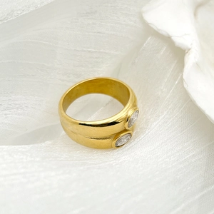 Macro detail of gold-plated stainless steel ring with two oval cubic zirconia stones