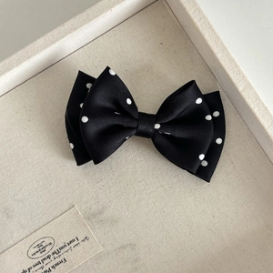 Elegant black and white polka dot satin bow hair claw clip for a retro chic look