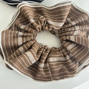Brown striped fabric oversized scrunchie with geometric patterns and white edging