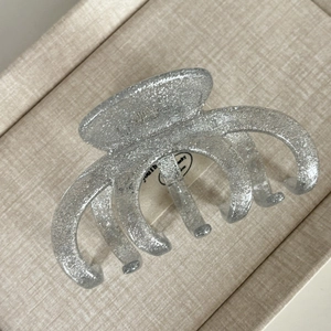 Detailed macro view of large silver glitter hair claw clip with strong metal spring