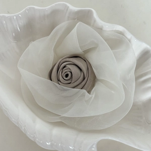 Pink and white rose flower hair clip made of sheer mesh organza in a seashell dish