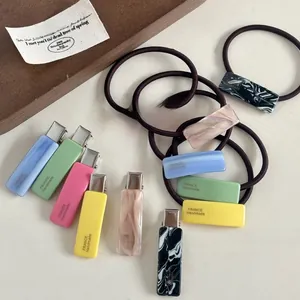 Detailed macro view of colorful acetate hair clips and elastics with France handmade engraving