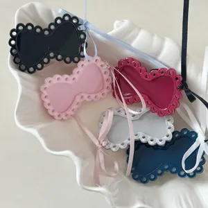 Sweet hollow bow hair clips in multiple colors displayed on a white shell plate