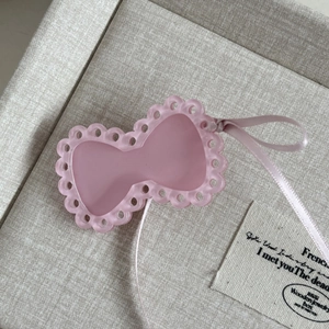 Pink ribbon bow hair clip with hollow edges and satin ribbon in minimalist style