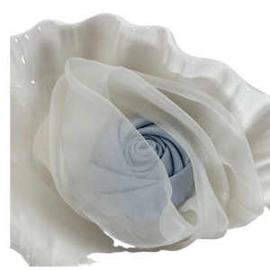 Elegant light blue fabric rose hair clip with white organza petals in a seashell
