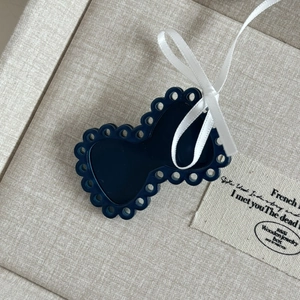 Sweet dark blue hollowed bow hair clip with white ribbon on a jewelry display box