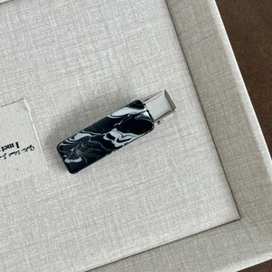 Close-up of marble pattern acetate hair clip with gold PRANCE Handmade lettering