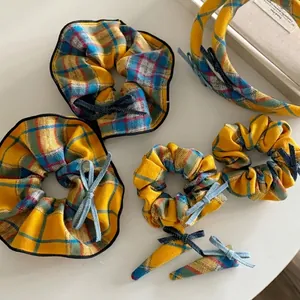 Vibrant mango yellow plaid hair accessory set with scrunchies, headbands, and clips