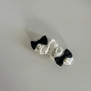 Elegant white polka dot lace hair clip with black bows and decorative pearls
