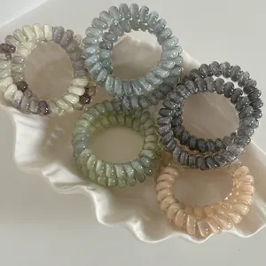 Five-pack of gradient spiral telephone wire hair ties in marble textures and solid colors
