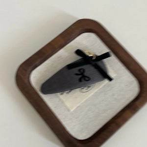 Elegant grey triangle hair clip with a stylish black ribbon bow and gold metal buckle