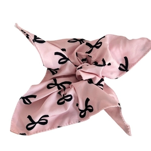 Pink satin square scarf hair tie with black bow print pattern on white background