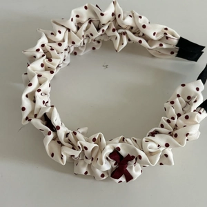 Cream polka dot headband with dark red ribbon bow and ruched fabric design for women