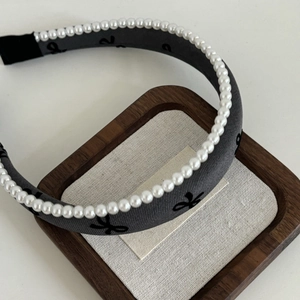 Elegant grey fabric headband with white pearls and minimalist bow pattern decoration