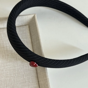 Elegant black striped headband featuring a small glossy red heart detail on the side