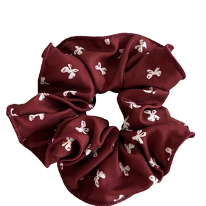 Deep burgundy scrunchie with white bow patterns on soft fabric for women