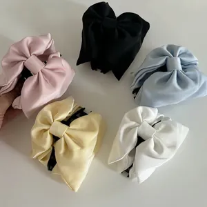 Elegant satin bow hair claw clips in five colors including pink black and blue for women
