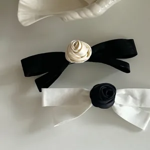 Elegant French satin bow hair clips with rose detail in black and white minimalist style