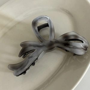 Elegant marble grey ink pattern bow hair claw clip made of acetate on ceramic tray