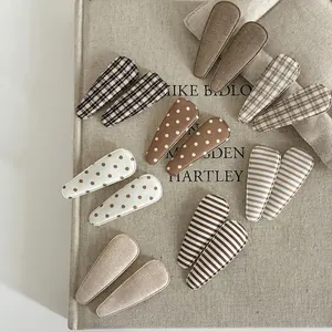 14-piece set of handmade earth-tone fabric hair clips with polka dots and plaid patterns