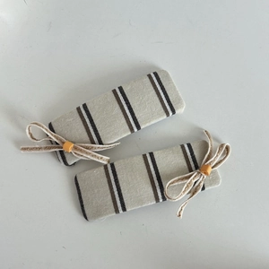 Pair of striped canvas hair clips with off-white bow knots and yellow beads