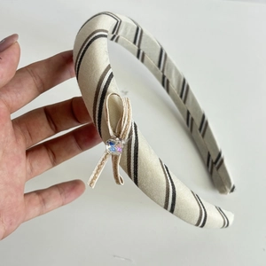 Beige lace stripe headband featuring a small bow with a sparkling crystal center