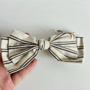 Minimalist striped lace bow hair clip in beige cotton linen fabric for elegant hairstyling
