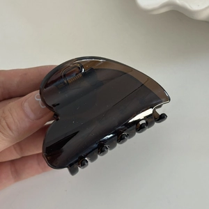 Brown heart-shaped hair claw clip in translucent resin for elegant updos hairstyles