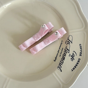 Set of two vintage pink polka dot bow hair clips with elegant rhinestone center