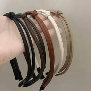 Set of five thin knotted PU leather headbands in assorted classic neutral colors