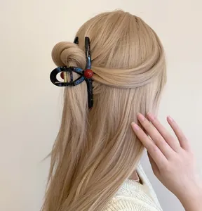 Detail of red polka dot pearl shark clip holding blonde hair in half-up hairstyle