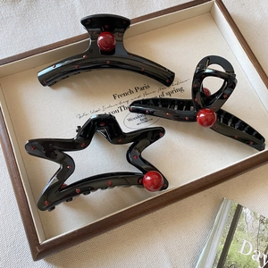 Three elegant black glossy hair claws with large red pearls and vintage resin details