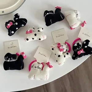Cute plush cat hair clips and ties set with pink bows and pearl details on white background