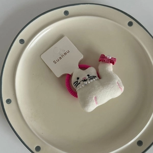Cute white plush cat hair tie with pink bow and pearl collar on display card