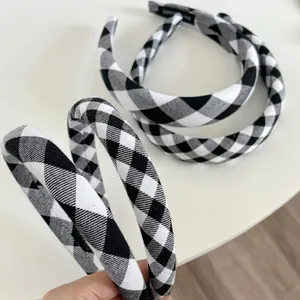 Classic black and white houndstooth headband with elegant woven fabric texture