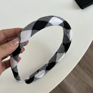 Classic black and white houndstooth headband with minimalist plaid design for women