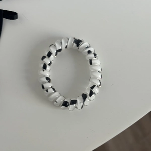 Spiral telephone wire hair tie with a classic black and white color block design