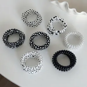7-piece black and white spiral telephone wire hair ties set with star and polka dot patterns