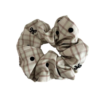 French style beige plaid scrunchie with black polka dots and a small bow tie detail
