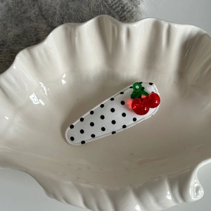 Polka dot cherry BB hair clip with red fruit decor on white shell jewelry tray