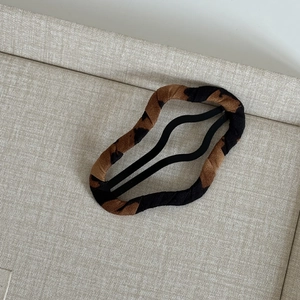 Leopard print square BB hair clip with retro wave design on a beige textured background