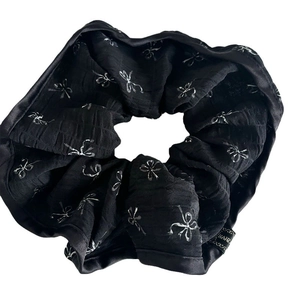 Elegant large black scrunchie with silver bow patterns and premium satin texture