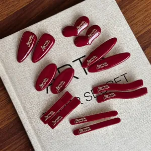 French style burgundy red hair clip set with golden barrette lettering on white book