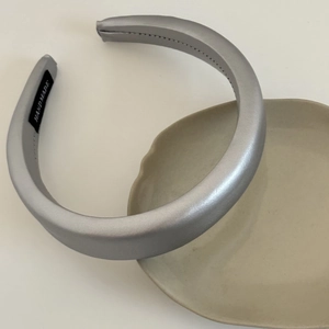 Minimalist silver satin padded headband with smooth pearlescent texture for women