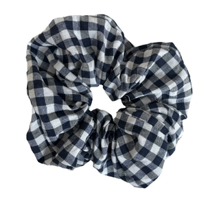 Sweet black and white gingham fabric scrunchie with soft cotton texture and elastic band