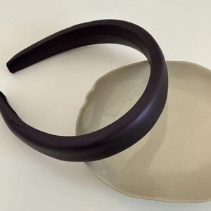 Minimalist deep purple padded sponge headband with matte leather finish and fine stitching